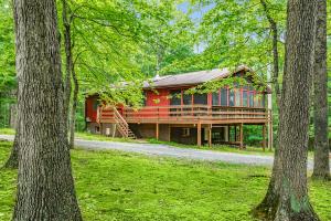 a house in the middle of a forest with trees at Hot Tub, River&Kayak, WiFi, & Fire Pit at Cabin! in Morton Grove