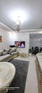 a living room with a couch and a flat screen tv at Mansbay beach in Aïn Harrouda