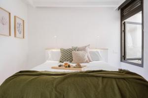 a bedroom with a bed with a tray of fruit on it at 11 Holiday Homes in San Miguel de Abona