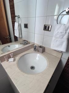 a bathroom with a large white sink and a tub at Estudio Edif valle Cóndores en valle Nevado SKIOUT Servicio HOM in Lo Barnechea