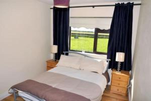 a bedroom with a bed and a large window at Islands View in Wexford