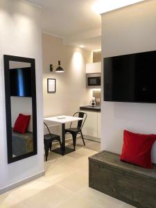 a living room with a table and a dining room at Su Coru 2 - Deluxe Studio in the Heart of Cagliari in Cagliari