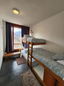 a room with three bunk beds and a window at Edif Mirador del Inca Espectacular Loft En Valle Nevado 10PAX Piscina in Lo Barnechea