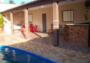 a house with a swimming pool and a patio at Espaço Foz com piscina e garagem gratuita in Foz do Iguaçu