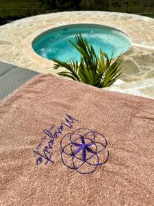 a towel with a peace sign on it next to a swimming pool at Margarita Ecovillage in Miches