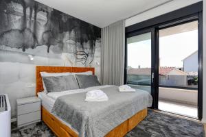a bedroom with a bed and a large window at Villa Didov San Family Residence with Pool in Zaton +67 photos