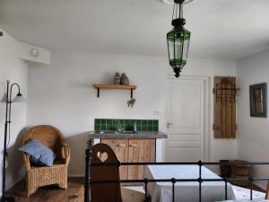 a room with a bed and a sink and a lamp at Moongarden apartment in Kováčovce
