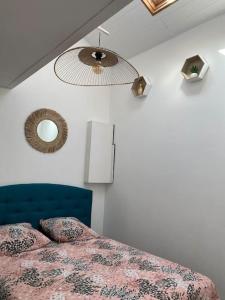 a bedroom with a bed and a mirror on the wall at Loft Biarritz proximité Mer et Golf in Biarritz