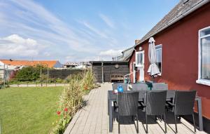 a patio with a table and chairs and a house at Pet Friendly Home In Bagenkop With Kitchen in Bagenkop