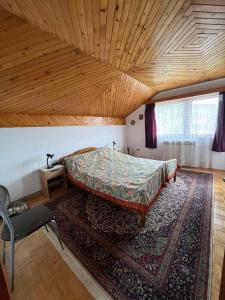 a bedroom with a bed and a rug at Guesthouse Vratnik in Sarajevo