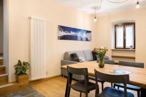 a living room with a table and a couch at Locanda Ca Bianca - Family Suite in Roccabruna +10 photos