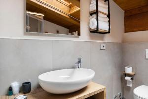 a bathroom with a white sink and a mirror at Locanda Ca Bianca - Family Suite in Roccabruna