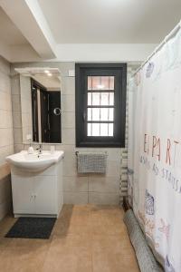 a bathroom with a sink and a shower curtain at Los Cardones Boutique Village in Playa de las Americas