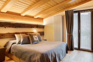 a bedroom with a bed and a large window at Locanda Ca Bianca - Family Suite in Roccabruna