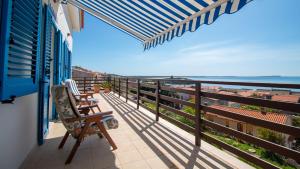 a balcony with chairs and a view of the ocean at Panorama Blu in S'archittu Cuglieri
