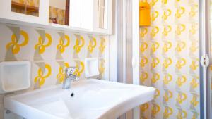 a bathroom with a sink and a mirror at Panorama Blu in S'archittu Cuglieri +20 photos