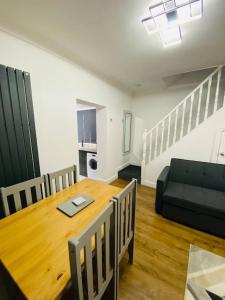 a living room with a table and a couch at Colston House in Newport