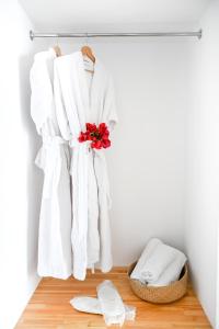 a pile of towels hanging on a rack in a bathroom at Makis Sea View Studios in Skiathos