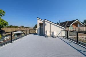 a large deck with two chairs and a building at Seattle Urban Village -Private Room- Vashon - Roof Top View Deck in Seattle
