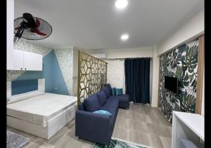 a room with a bed and a couch and a tv at Princess resort in Hurghada +81 photos