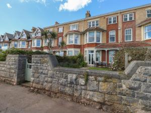 a brick apartment building with a stone retaining wall at Blue Yonder in Weymouth
