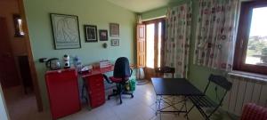 a kitchen with a desk and a table and chairs at Basilicò in Caltagirone