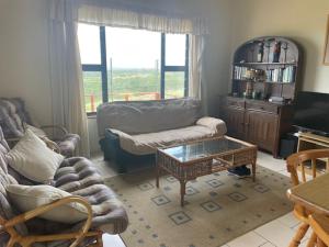a living room with a couch and a coffee table at Sea view cottage in Great Brak River
