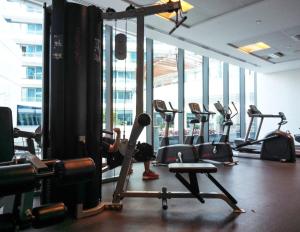 a gym with rows of exercise equipment in a building at Frank Porter - Silverene in Dubai