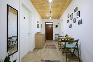 a hallway with a table and chairs and a wooden ceiling at Vila Vreko in Berat +37 photos