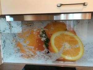 a close up of an oven with an orange at Haus Nicolai FeWo 8 in Baabe