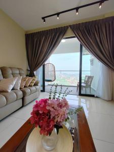 a living room with a vase of flowers on a table at YOU 1272sqft 3 Bed-Room Unit with Netflix WiFi in Cheras