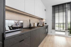 a kitchen with a sink and a counter top at Modern Apartment with Parking near Arena Gdansk by Renters in Gdańsk