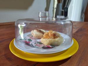 a plate with two biscuits in a glass container on a table at Fraai Maraai Self Catering Apartments in Groblersdal