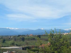 a view of snow covered mountains in the distance at Appartement ALERIA 2/4 personnes in Aléria +2 photos