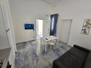 sala de estar con mesa y sofá en ALG Apartments con Parcheggio en Porto Cesareo