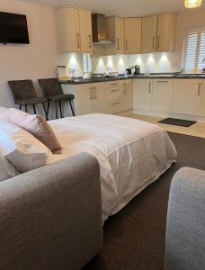 a kitchen with a large bed in a room at Cathedral Coach House - Lichfield in Lichfield
