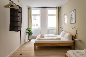a white bedroom with a bed and a window at Spacious Family Apartment with 2 Bedrooms in Berlin