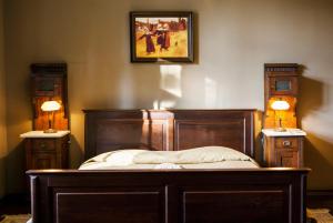 a bedroom with a bed with two lamps on the wall at Villa Pepita in Miedzygorze