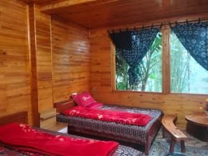 a log cabin with a bench and a window at Zoo si homestay in Sa Pa