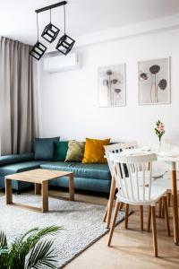 a living room with a couch and a table at Fully-furnished Apartment with Air Conditioning for families, Cracow Old Town in Kraków
