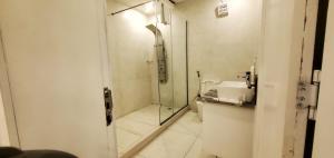 a bathroom with a sink and a shower at The Palms Hotel in Abuja