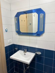 baño con lavabo y espejo en la pared en Apartament 1+1 en Yrsheku
