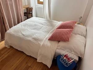 a bed with two pillows on it in a bedroom at Appartement d’artiste in Saint-Denis