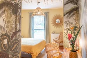 two views of a bedroom with a bed and a window at La Grange du Coulin in Onesse-et-Laharie