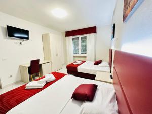 a hotel room with two beds and a television at Dream Hub in Mestre