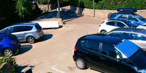 a group of parked cars in a parking lot at Guesthouse Cecilia 2 in Malinska