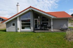 uma casa com um jardim de Inverno com um deque em Resort 2 Sea Lodge C 114 em Grossenbrode