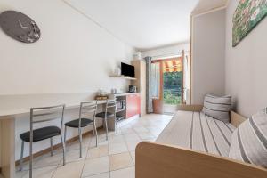 a living room with a bed and a table and chairs at Residence Tatiana A3 in Tremosine Sul Garda