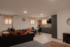 a living room with a couch and a kitchen at Saint Nektarios Ηouse Preveza in Preveza