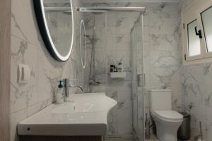a white bathroom with a sink and a toilet at Saint Nektarios Ηouse Preveza in Preveza +14 photos